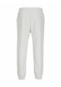 Pantaloni della tuta grigio chiaro realizzati in tessuto morbido, con una cintura elastica e polsini. Presentano un design a gamba affusolata per una vestibilità comoda.