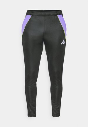 Zwarte sportbroek met paarse en groene accenten, slim fit, elastische tailleband en logo op de linker dij. Gemaakt van een gladde, lichte stof.