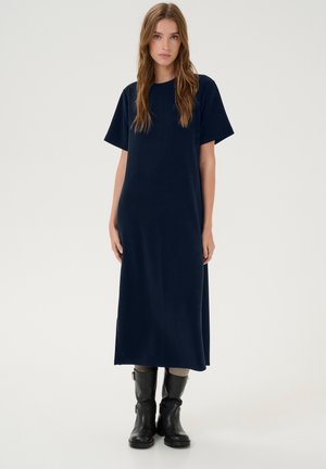 Navy blue cotton maxi dress with short sleeves and a relaxed fit, paired with black knee-high boots featuring buckle accents.