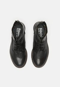 Botas de tobillo negras perforadas con cierre de cordones y cremallera lateral, con una textura de cuero suave y un forro interior de patrón colorido.
