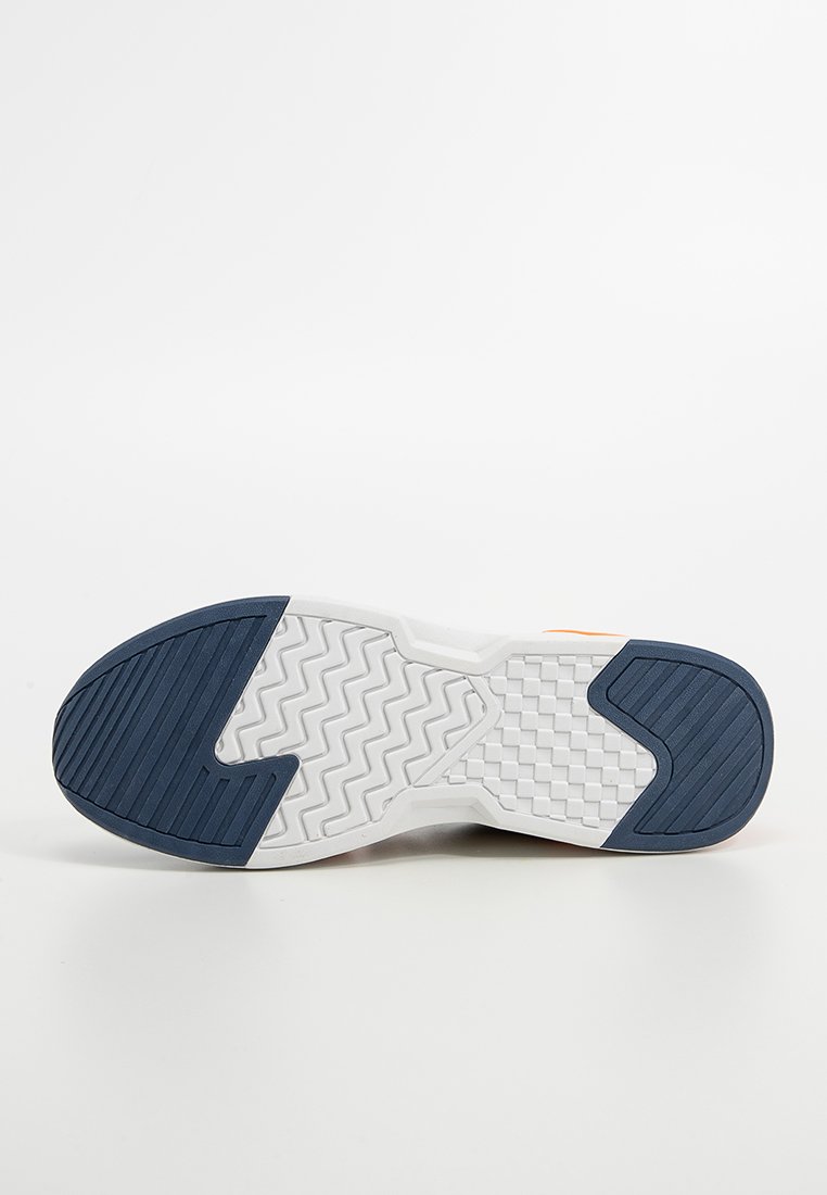 Schuhsohle mit einem weißen Körper und strukturiertem Gummi in Dunkelblau. Auffällige Zickzack- und Schachbrettmuster verbessern den Halt.