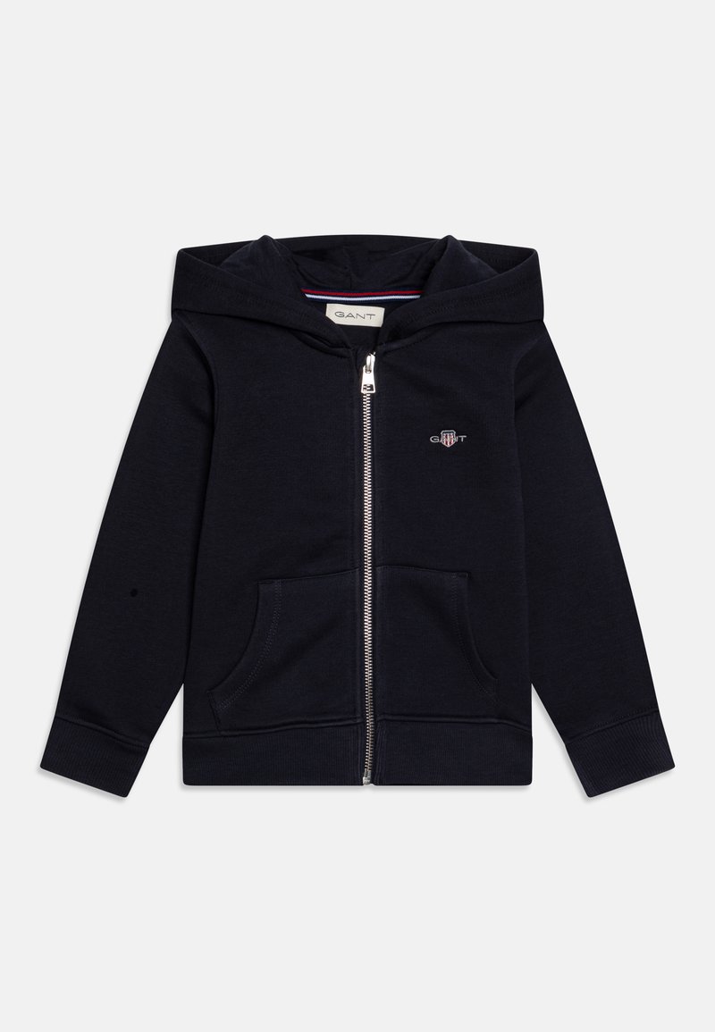 Mornarsko modra zip-up kapuca izdelana iz mehkega blaga, z zasnovo sprednjega žepa, rebrastimi manšetami in majhnim logotipom na prsih.