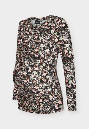 Czarna bluzka ciążowa z długim rękawem, ozdobiona kwiatowym nadrukiem w kolorach różowym, białym i zielonym. Miękki, elastyczny materiał. Okrągły dekolt.