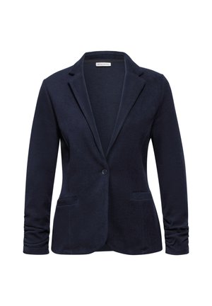 Blazer bleu marine en tissu doux avec une fermeture à un bouton, deux poches avant et un col cranté.