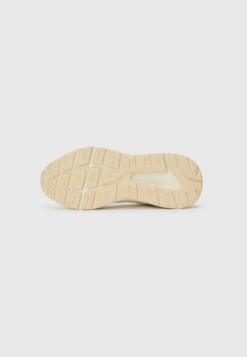 Sohle eines Sneakers mit einer strukturierten Gummiaußensohle, in hellem Beige und einem ausgeprägten Profil für Grip und Traktion.