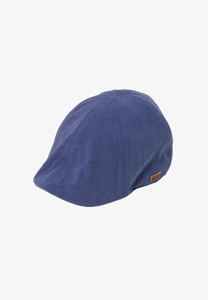 Blue flat cap with visible stitched panels and small brown leather brand tag on the side.