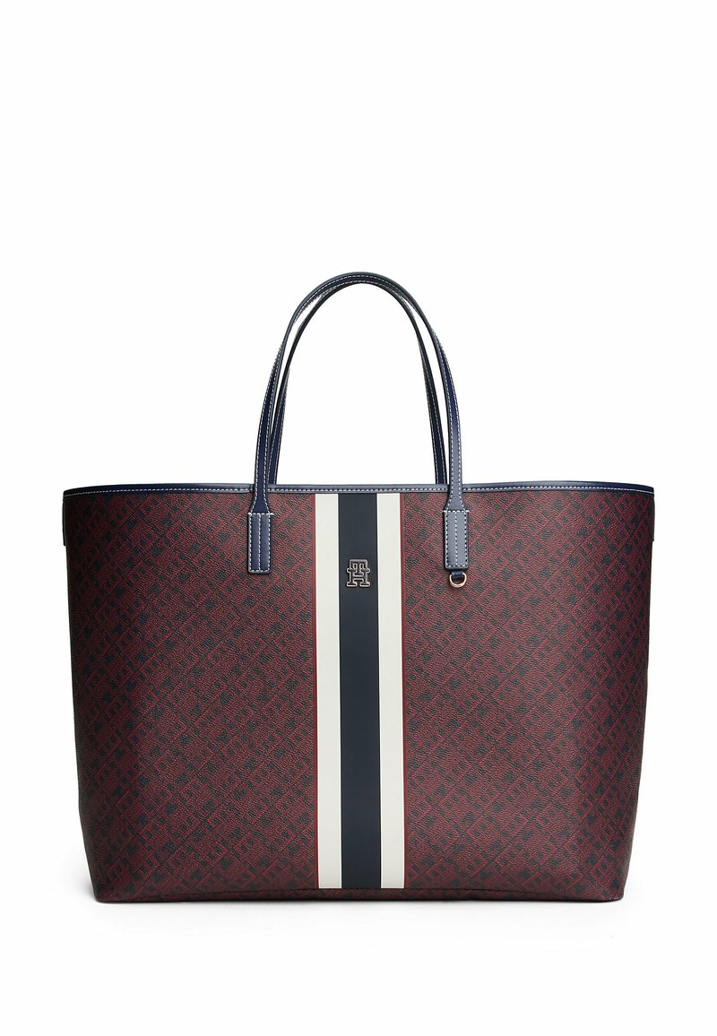 Borsa a spalla con motivo rosso, due manici blu scuro, una striscia centrale bianca e dettagli del logo. Realizzata in materiale sintetico. Forma strutturata.