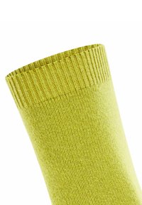 Grüne Baumwollsocke mit geripptem Bund, ausgestattet mit einer glatten gewebten Textur und einem mittellangen Design. Geeignet für den täglichen Gebrauch.