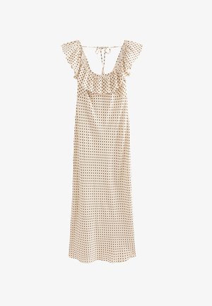 Robe beige sans manches avec des pois noirs, col à volants et détail noué dans le haut du dos, style longueur cheville.