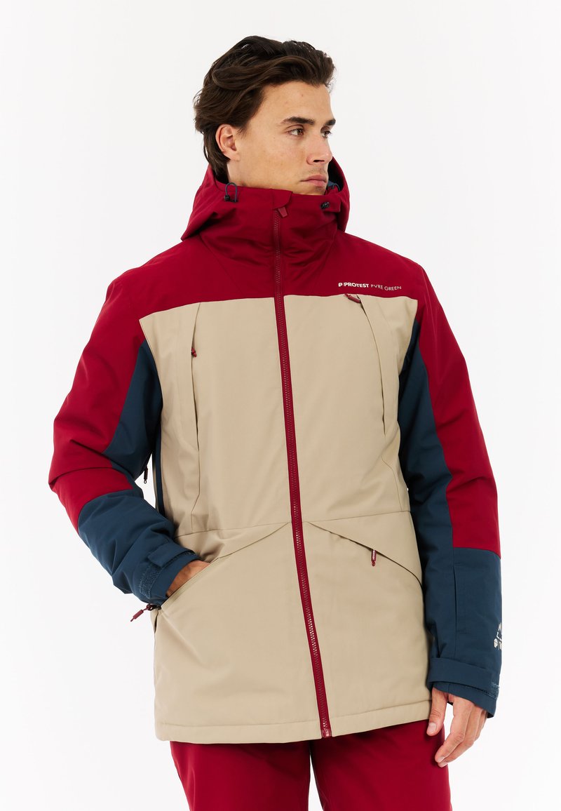 Männer Winterjacke mit beigem Körper und roten sowie marineblauen Akzenten, einem Reißverschluss vorne, verstellbare Kapuze und seitlichen Taschen. Strapazierfähiger Stoff.