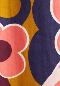 Stoff mit auffälligen Blumenmuster in Pink, Lila und Senfgelb, mit einer glatten Textur und einem lebhaften Farbkontrast.