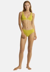 Set di bikini giallo in pizzo con top a triangolo dotato di spalline larghe e slip a vita bassa, entrambi caratterizzati da intricate trame testurizzate.