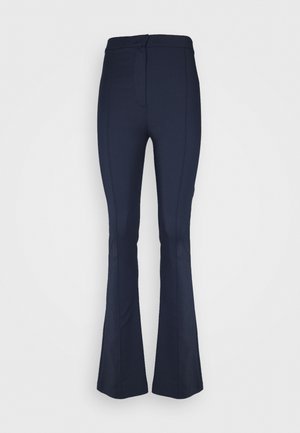 Navy flared trousers made from a stretchy fabric. Features a flat waistband and vertical seam details along the front for a tailored look.