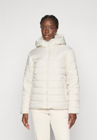 Puffer jacket in light cream with a zippered front, hood, and ribbed cuffs. Features horizontal quilted pattern and side pockets.