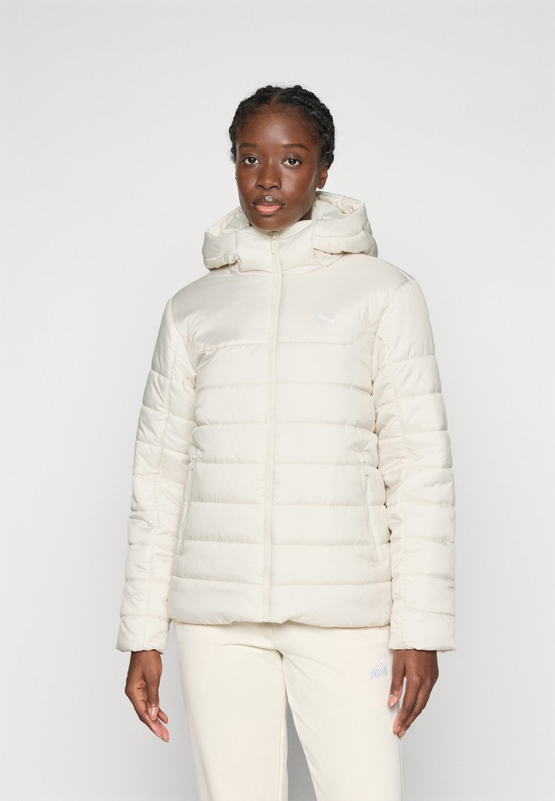Puffer jacket in light cream with a zippered front, hood, and ribbed cuffs. Features horizontal quilted pattern and side pockets.