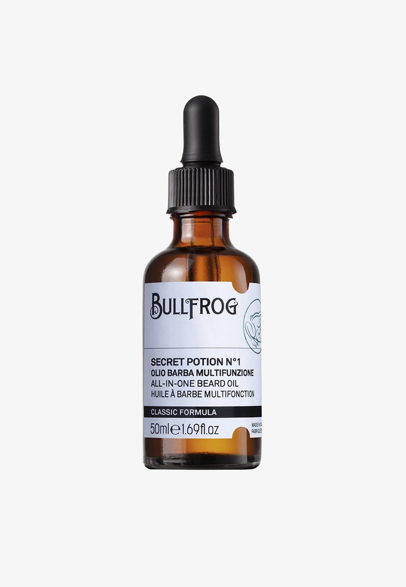 Bernsteinfarbene Glasflasche mit schwarzer Pipettenkappe. Weiße Etikett zeigt "Bullfrog Secret Potion N°1" und Produktdetails in schwarzem Text.