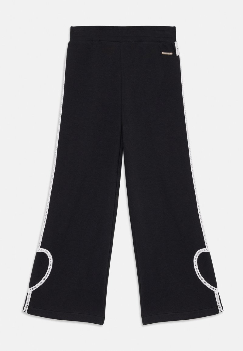 Svart vide bukser laget av mykt stoff, med hvite side-striper og et utskåret akzent, samt elastisk midjebånd for komfort.