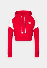 Felpa corta rossa con maniche bianche, cappuccio con coulisse e pon-pon. Presenta un logo sul petto e un design a blocchi di colore.