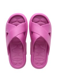 Pink plastic slide sandals featuring a crisscross strap design, textured footbed with oval patterns, and a smooth, matte finish.