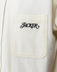 White canvas jacket featuring a left chest pocket with "JACKER" embroidered in black. Stitched details in contrasting tan thread.