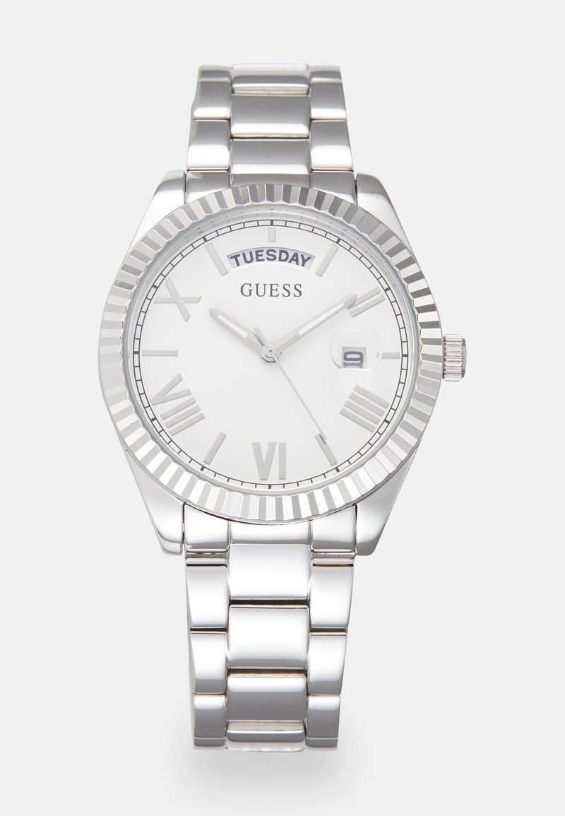 Silver stainless steel watch with a round white dial, Roman numerals, day display, and a polished bezel. Features a link bracelet design.