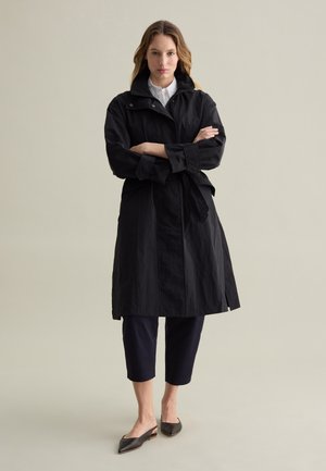 WITH ZIP AND BUTTONS - Trenchcoat - black