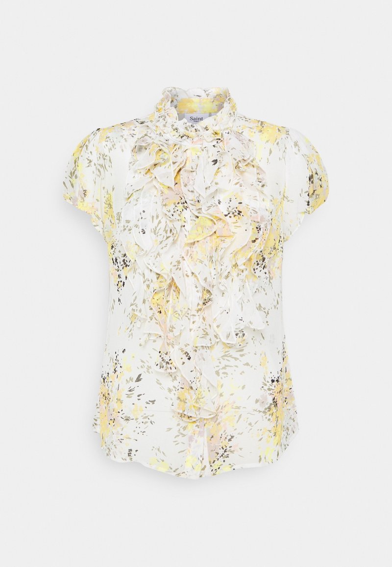 Bloes met bloemenprint in lichte stof en korte mouwen. Heeft een gerimpelde voorkant, voornamelijk geel en wit met zachte roze accenten, en een kraag.