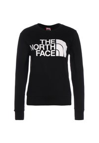 Sudadera negra hecha de una mezcla de algodón, con un gran texto de logo en blanco "THE NORTH FACE" en el pecho, y puños y dobladillo acanalados.