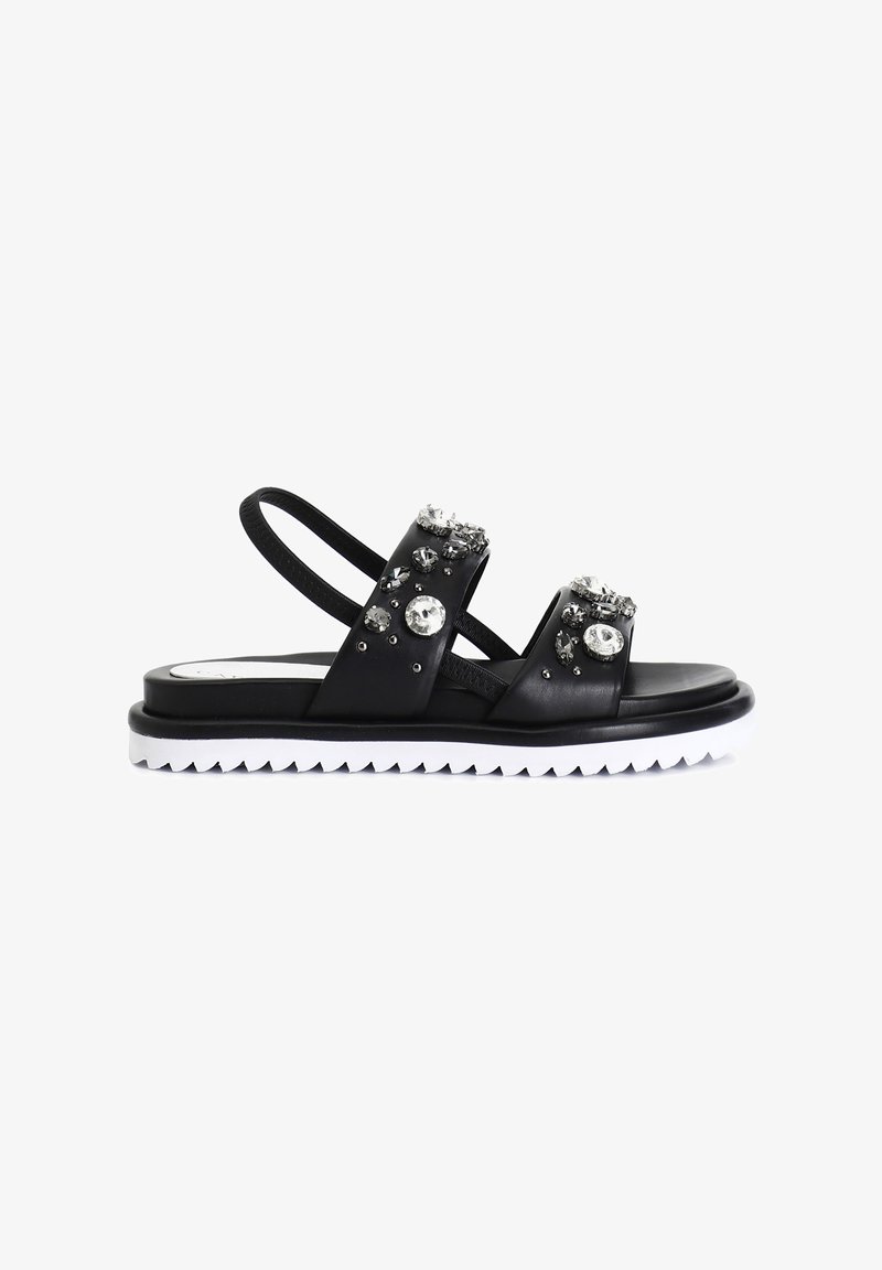 Černé sandály se dvěma zdobenými pásky s čirými a šedými drahokamy. Texturovaná gumová podrážka s bílým cik-cak vzorem. Nastavitelný zadní pásek.