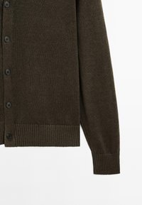 Dark green knit cardigan featuring a v-neck, six black buttons, ribbed cuffs, and a ribbed hem, textured fabric with a smooth finish.