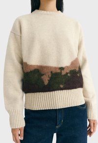 Knit sweater made of cream-colored wool, featuring a horizontal design with brown, green, and dark purple accents. Ribbed hem and cuffs.