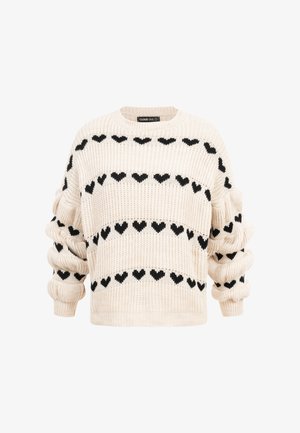 Pull en maille crème avec des motifs de cœurs noirs disposés en rangées horizontales et manches froncées.