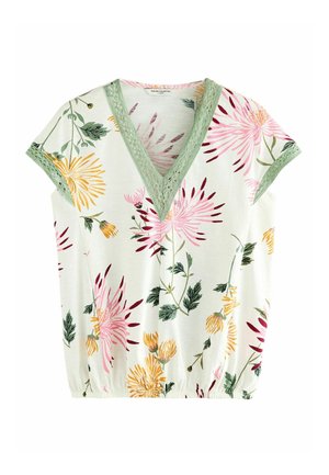 White short-sleeve blouse with green lace-trimmed V-neck and floral print in pink, yellow, and green leaves and stems.