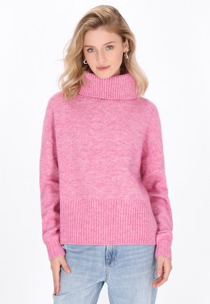 Maglione rosa a dolce vita con orlo e polsini a coste, realizzato in tessuto morbido, caratterizzato da una vestibilità comoda e una finitura testurizzata. Abbinato a jeans azzurri chiari.