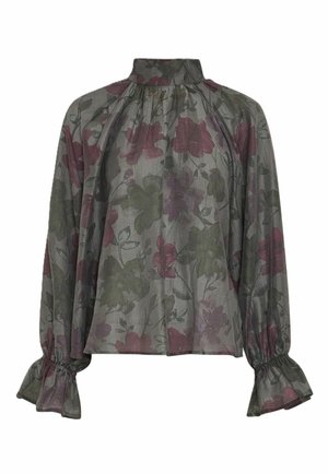 Blouse transparente à manches longues, col montant, poignets élastiques à volants et motif floral discret dans des tons vert foncé et bordeaux.