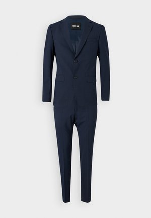 Costume bleu marine avec un blazer ajusté à deux boutons, des revers en pointe et un pantalon slim assorti avec des poches avant.