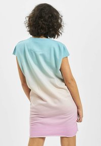 Short-sleeve, ombre dress transitioning from blue at the top to pink at the hem. Soft fabric with a relaxed fit and raw edge at the bottom.