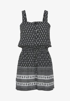 Rompers noirs avec un motif floral blanc, bretelles réglables, devant à boutons, taille élastique et bande imprimée en bas. Tissu léger.