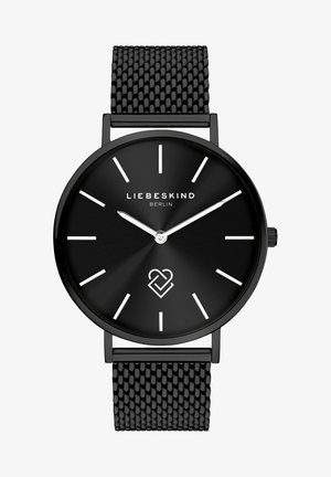 Sort rundt analogur med en børstet sort skive, sølv timeindekser og et sort mesh-armbånd; har brandnavnet og et hjerte logo.