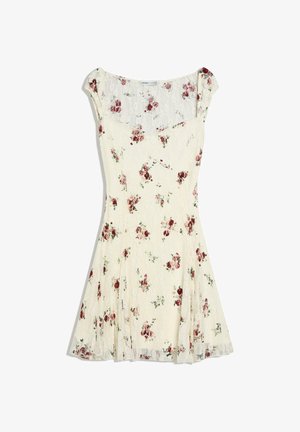 Robe en dentelle crème avec manches courtes type « cap » et petit imprimé floral rouge et rose, taille cintrée et jupe évasée.