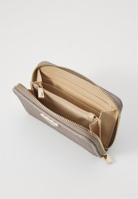 Light brown wallet with textured outer material, gold zipper, and multiple compartments. Features smooth beige interior with card slots.