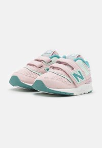 Pink and turquoise children's sneakers with a mesh upper, Velcro straps, and a textured sole. Features a prominent "N" logo on the side.