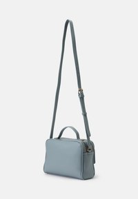Jasnoniebieska skórzana torebka typu crossbody o teksturowanej powierzchni, z regulowanym paskiem, uchwytem u góry i złotymi elementami. Kompaktowy, prostokątny kształt.
