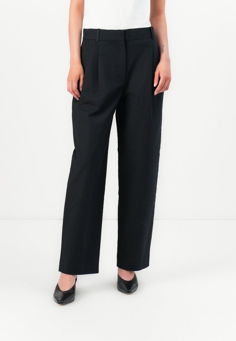 Black tailored trousers with a high waist, pleats, and straight legs. Made from a smooth fabric, featuring a classic design and minimal hardware.
