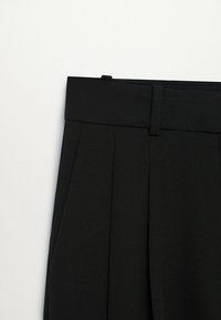 Czarne spodnie o dopasowanym kroju, z płaskim przodem, ozdobione dwoma pionowymi zakładkami oraz gładkim, usztywnionym paskiem w talii, co nadaje elegancki wygląd.