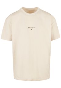 Cream short-sleeve cotton t-shirt featuring a small brown graphic text and star detail on the front, with a relaxed fit and standard crew neck.