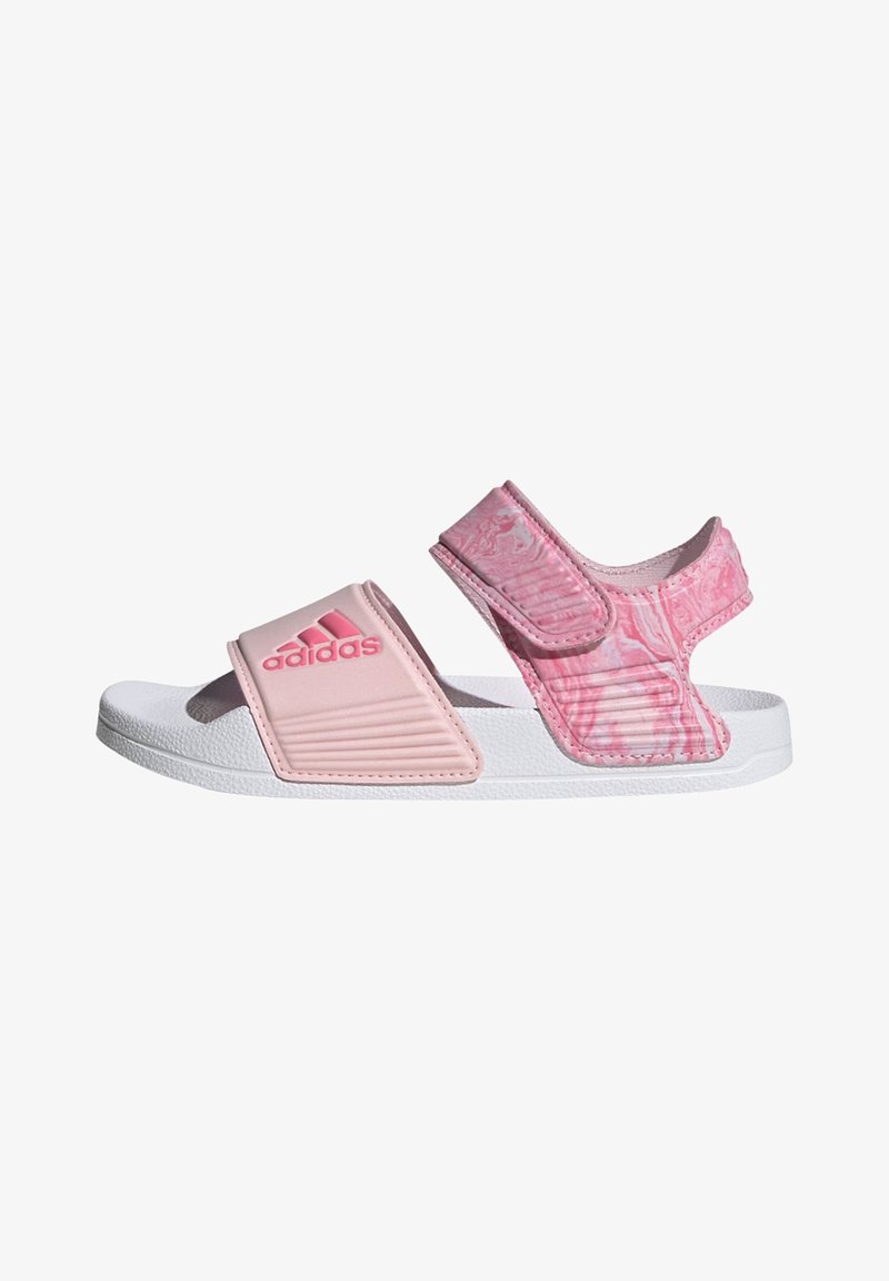 Roza drsna sandal, ki ima teksturiran trak z vzorčastim poudarkom in belo gumijasto podplato. Nastavljiv Velcro trak zagotavlja varno prileganje.