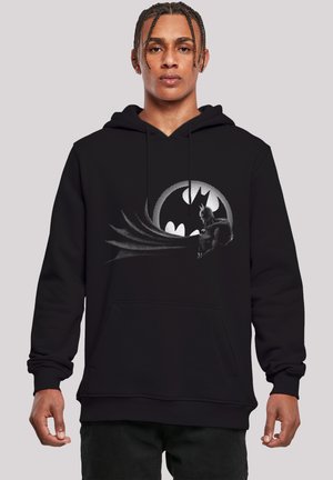 Black hoodie featuring a graphic of a bat silhouette and logo on the front. Material appears soft with a relaxed fit and front pocket.