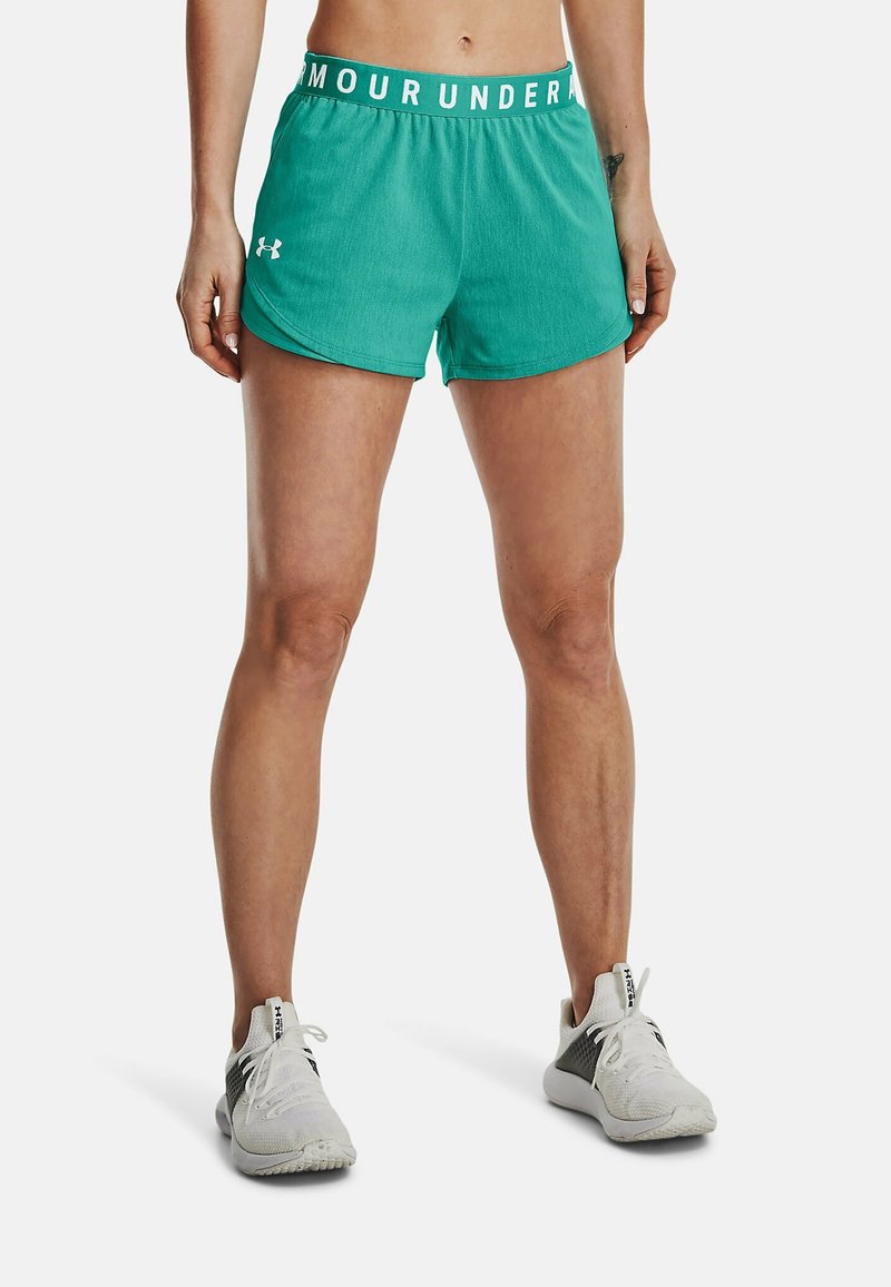Shorts de sport turquoise avec une taille élastique blanche portant le texte "ARMOUR". Le tissu semble léger et lisse.
