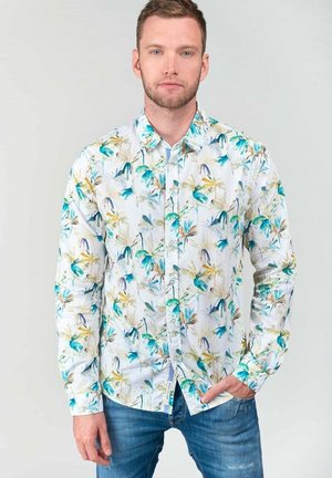 Witte overhemd met knopen, versierd met levendige bloemenpatronen in groene, blauwe en gele tinten. Gemaakt van lichte stof met lange mouwen.